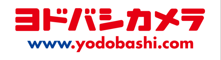 The image shows the Yodobashi Camera logo in Japanese red text above the website URL www.yodobashi.com in blue and red letters on a white background.