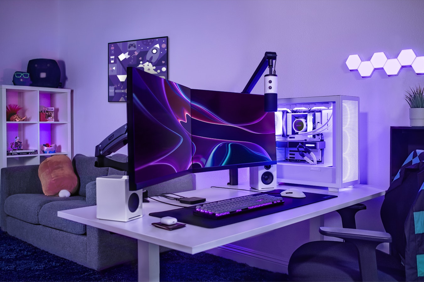 Angled shot of an office with two NZXT 27" Canvas monitors, Function Keyboard, Lift Mouse, Capsule Microphone and Boom Arm, and H7 Flow Case and custom pc