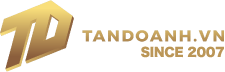 Gold geometric “TD” logo next to the text “TANDOANH.VN SINCE 2007” in gold lettering on a black background.