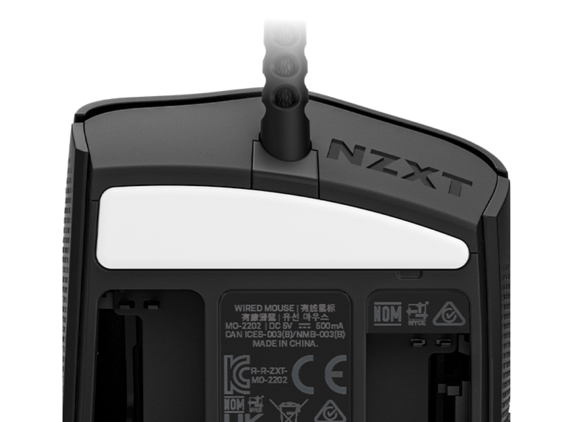 Close-up of the underside of a black NZXT wired computer mouse, showing the brand name, a white removable cover, product labels, certification logos, and a cable attached at the top.