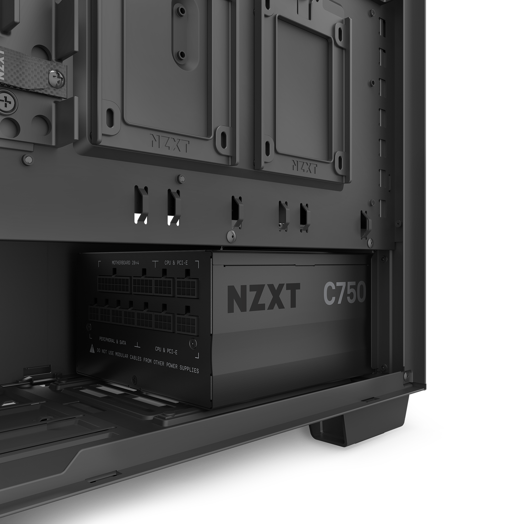 Close-up of a computer case interior with an NZXT C750 Gold modular power supply installed at the bottom, its cable ports visible below the motherboard tray.
